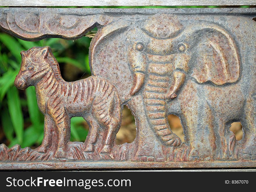 Close up of two animal figures on a children's bench. Close up of two animal figures on a children's bench