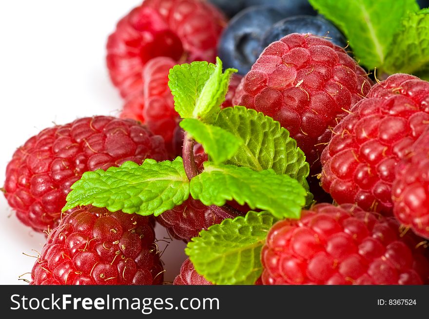 Fresh ripe raspberry and blueberry with green mint leaves. Fresh ripe raspberry and blueberry with green mint leaves