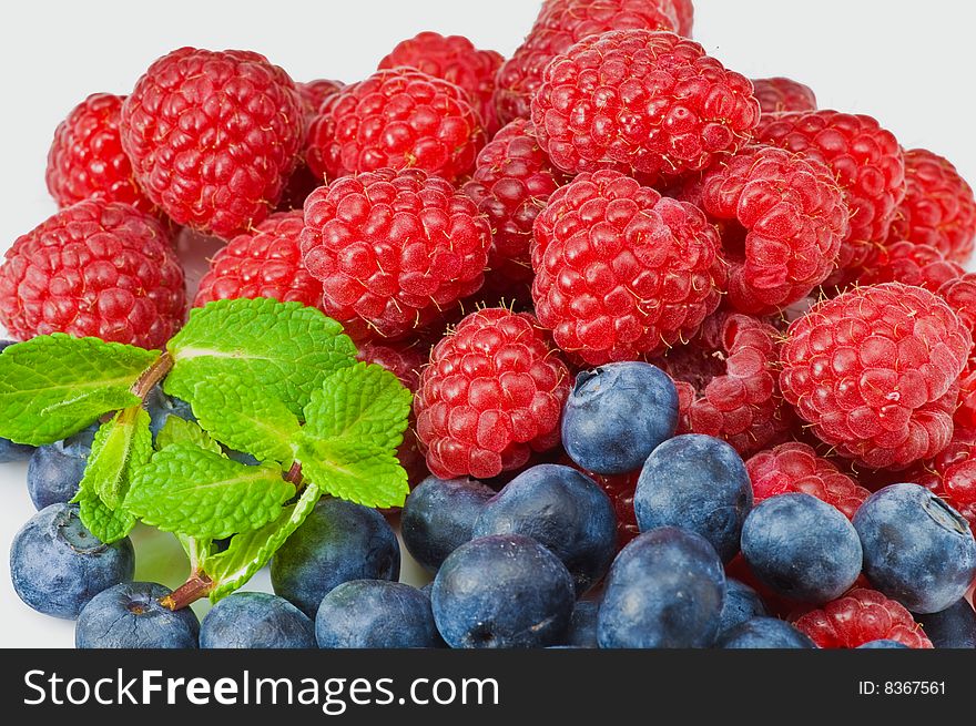 Fresh ripe raspberry and blueberry with green mint leaves. Fresh ripe raspberry and blueberry with green mint leaves