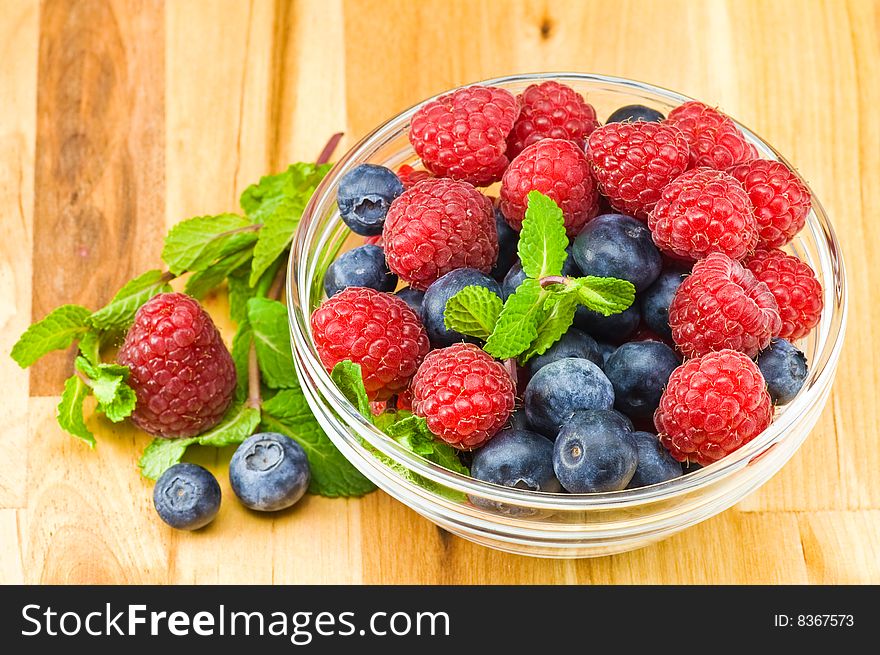 Fresh ripe raspberry and bluberry in glass jam-dish. Fresh ripe raspberry and bluberry in glass jam-dish