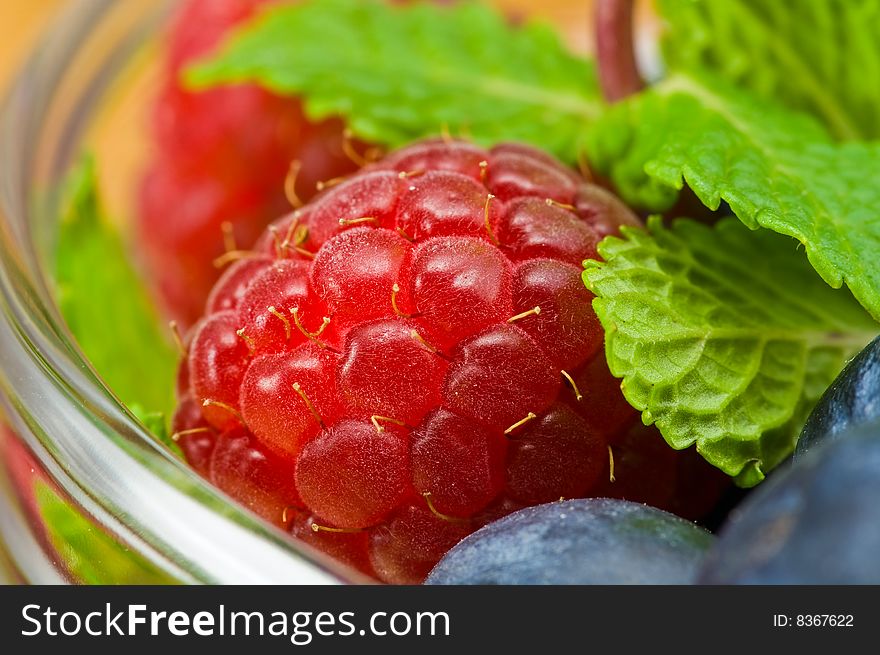 Fresh ripe raspberry and bluberry in glass jam-dish. Fresh ripe raspberry and bluberry in glass jam-dish