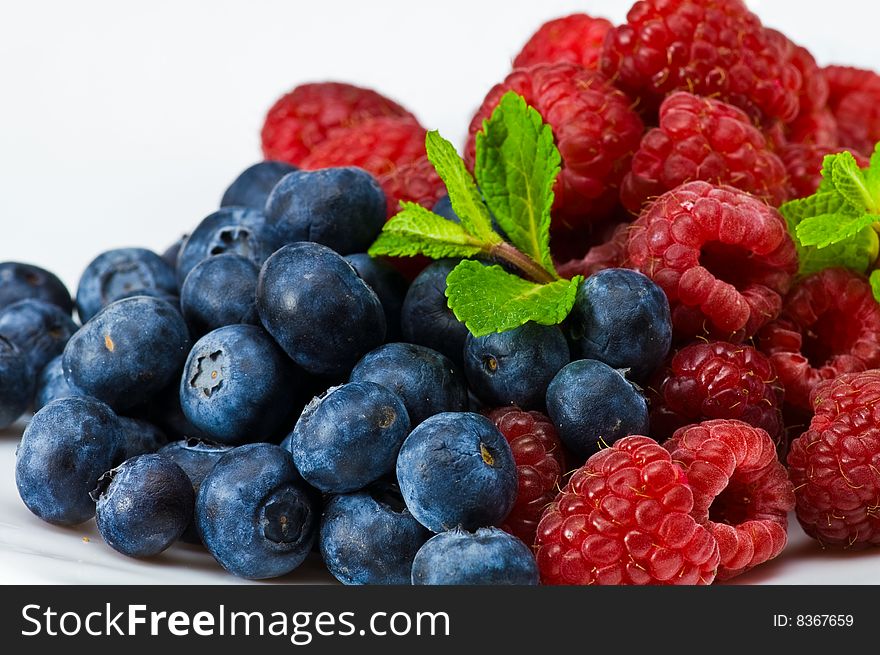 Fresh ripe raspberry and blueberry with green mint leaves. Fresh ripe raspberry and blueberry with green mint leaves