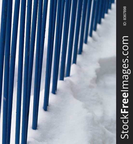 Blue iron railing in snow