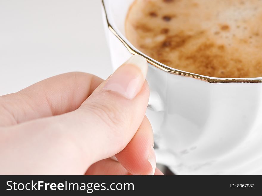 Cup of aromatic cappuccino with a hand. Cup of aromatic cappuccino with a hand