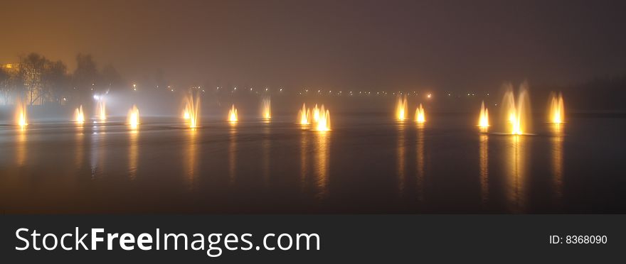 Illuminated fountains on a foggy night in Oulu, Finland. Illuminated fountains on a foggy night in Oulu, Finland