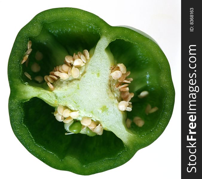 Half a green pepper on a white background