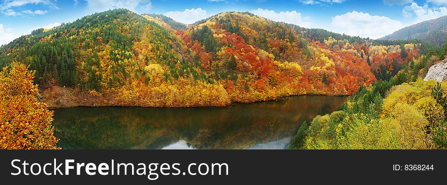 Colorful autumn lake and big mountain