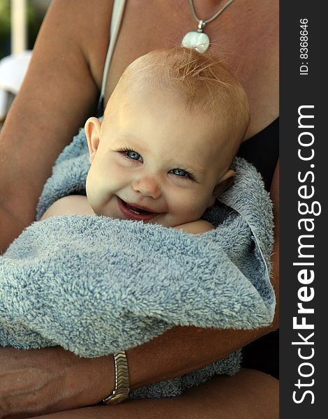 Smiling baby in a bath towel