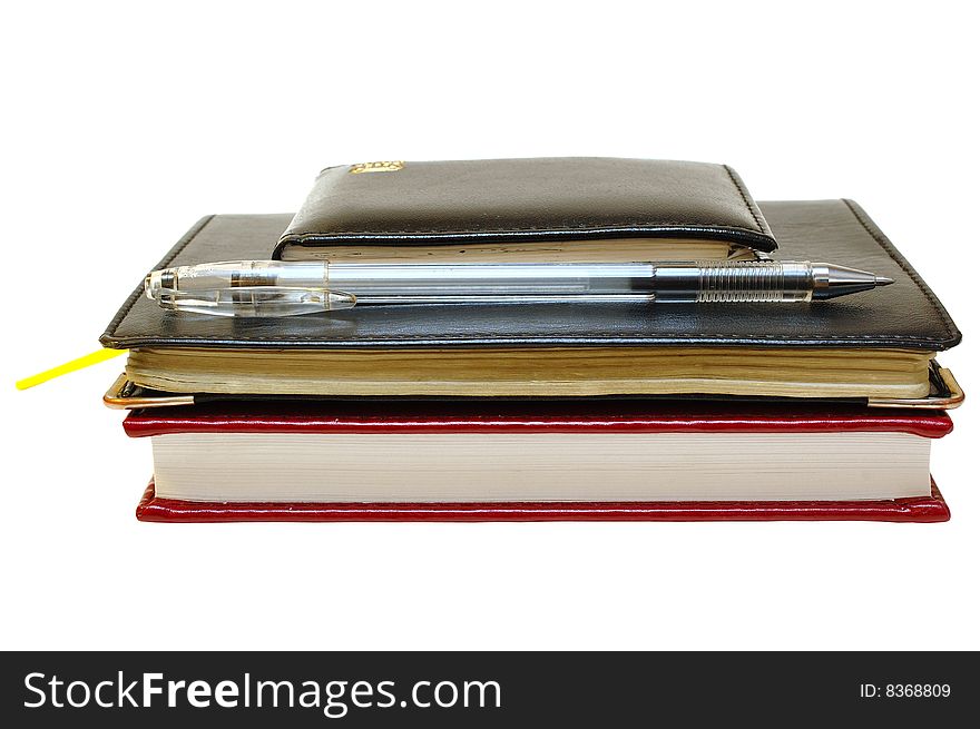 Three notebooks (organizers) and jell pen on isolated background. Three notebooks (organizers) and jell pen on isolated background.