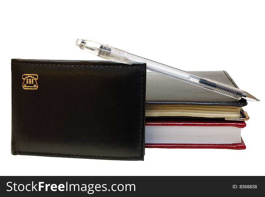 Three notebooks (organizers) and jell pen on isolated background. Three notebooks (organizers) and jell pen on isolated background.