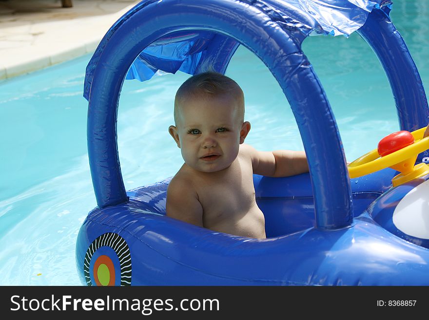 Baby in an inflatable toy in a pool. Baby in an inflatable toy in a pool