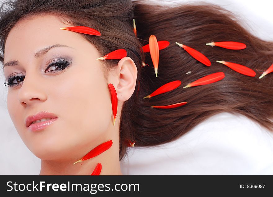 Portrait of a beautiful woman with red petals. Portrait of a beautiful woman with red petals