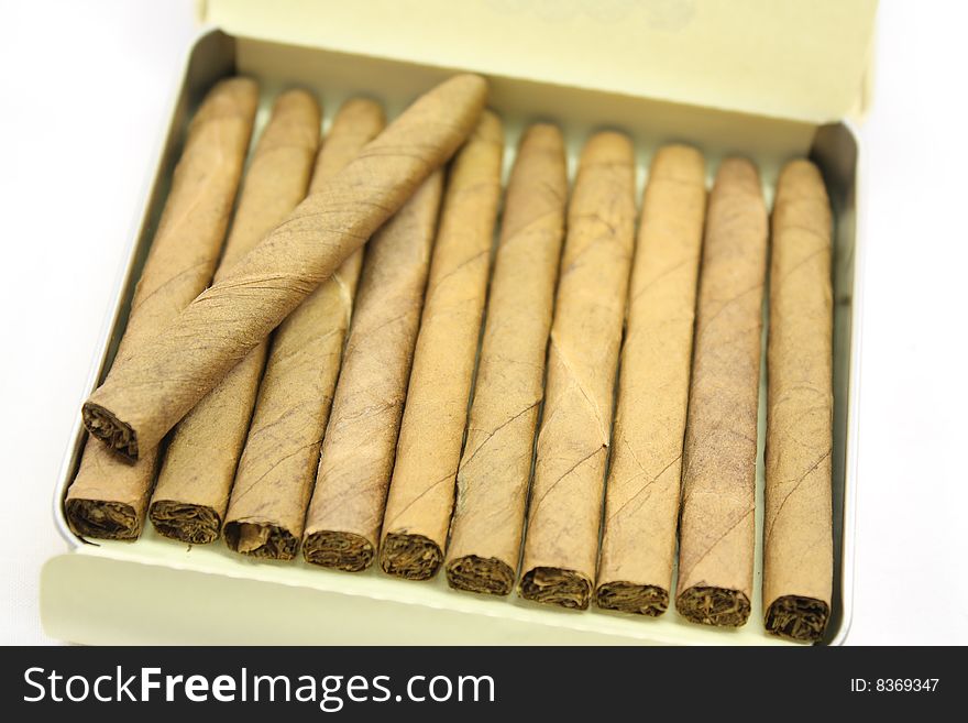 Tin of small hand rolled cigars ready for smoking. Tin of small hand rolled cigars ready for smoking.