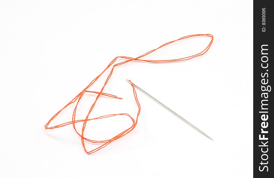 Red string and needle isolated on white background. Red string and needle isolated on white background.