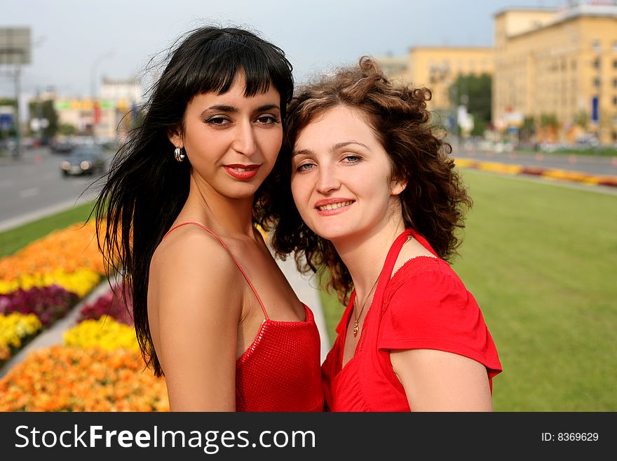 Two girls in city in sunny day. Two girls in city in sunny day