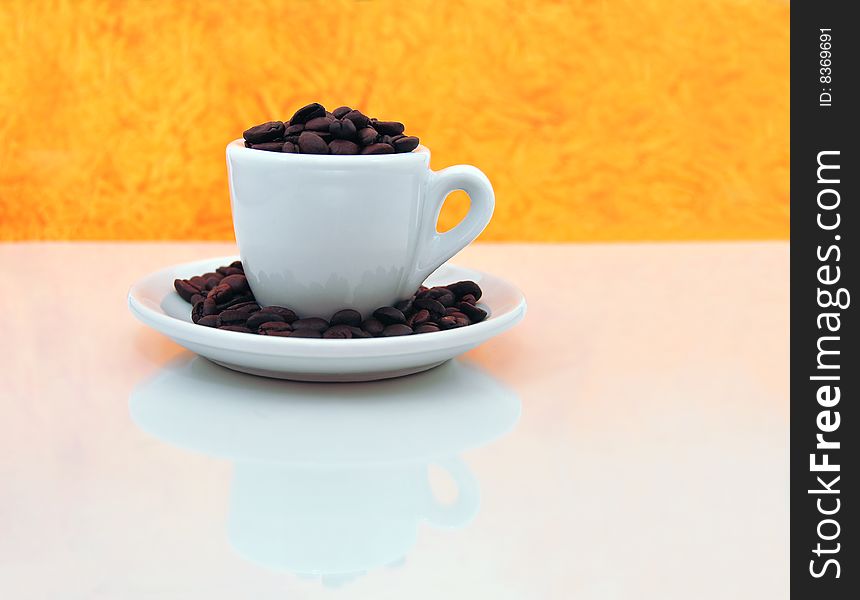 Roasted coffee beans on top of a rugged carpet painted with the Colombian flag colors. Roasted coffee beans on top of a rugged carpet painted with the Colombian flag colors.