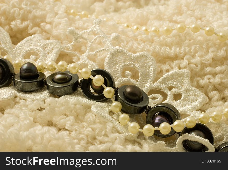 White and black pearls on doll hair wool. White and black pearls on doll hair wool