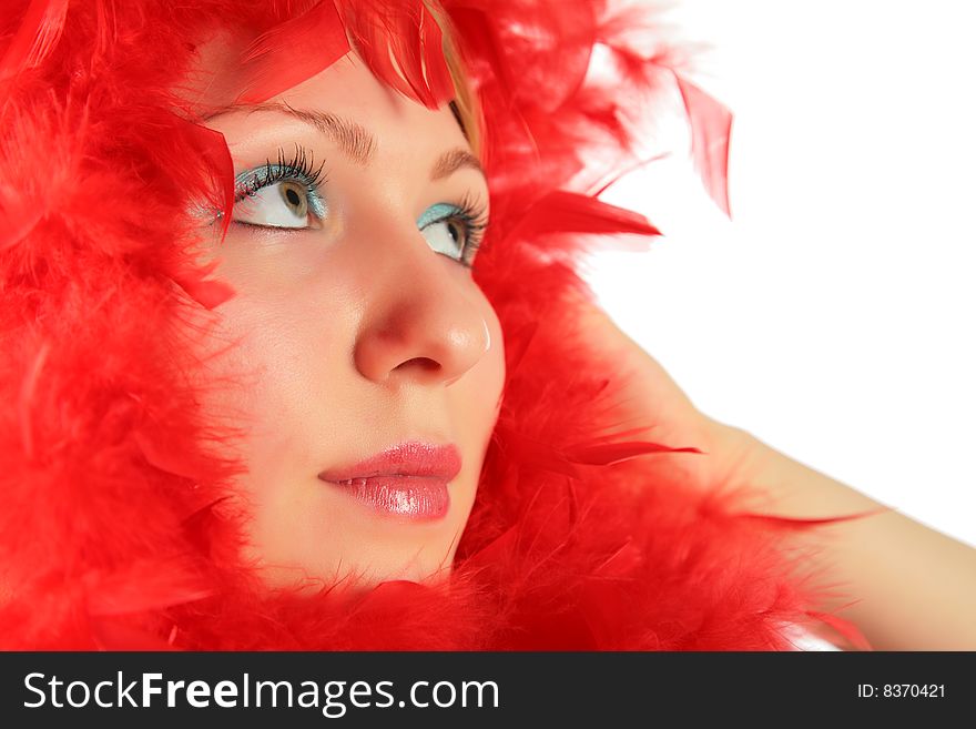 Portrait of girl in red feathers on white background