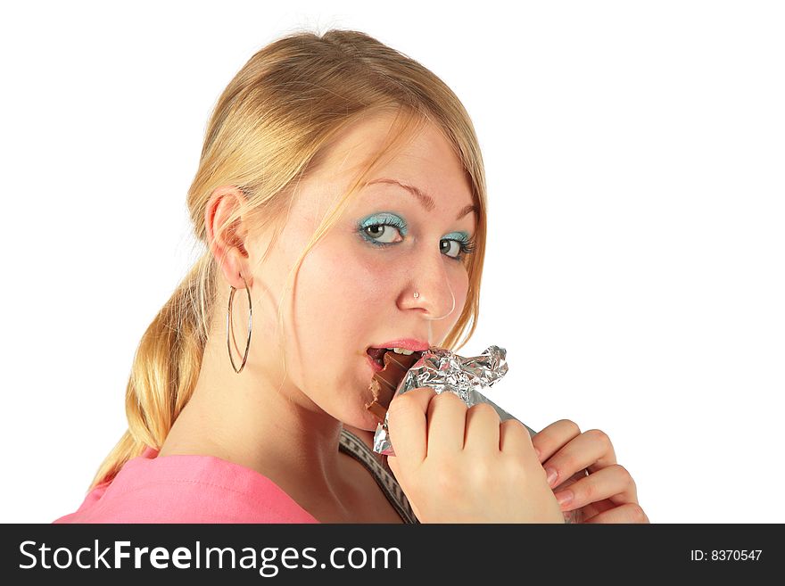 Young girl eats chocolate on white background