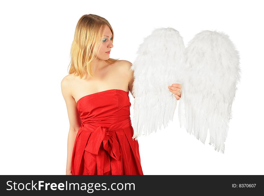 Blonde girl in red dress holds  angel's wings on white background. Blonde girl in red dress holds  angel's wings on white background
