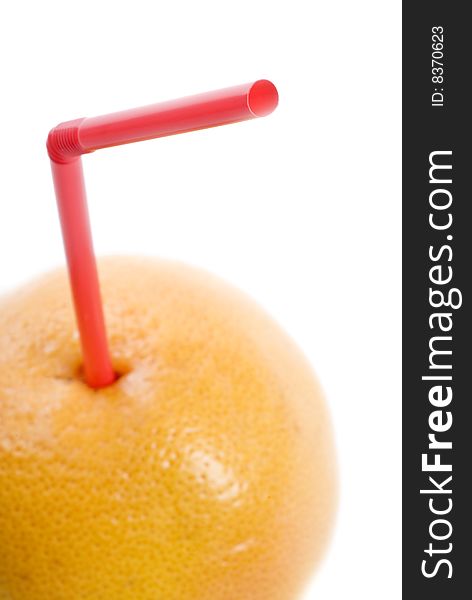 A pink straw is inserted into a grape fruit. A pink straw is inserted into a grape fruit.