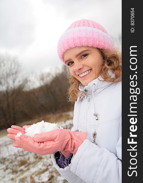 Young Beauty Girl Outdoor In Winter Holds Snow