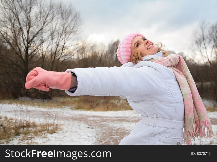 Young beauty girl  in wood in winter with stretched hands. Young beauty girl  in wood in winter with stretched hands