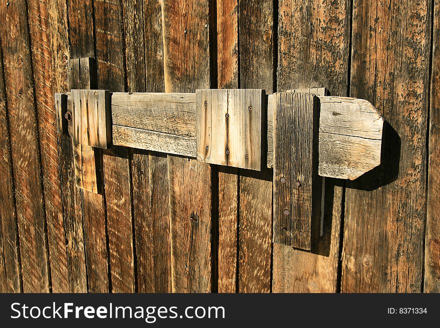 A wooden latch hold back barn doors. A wooden latch hold back barn doors