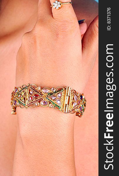 Golden bracelet looking great on models hand.