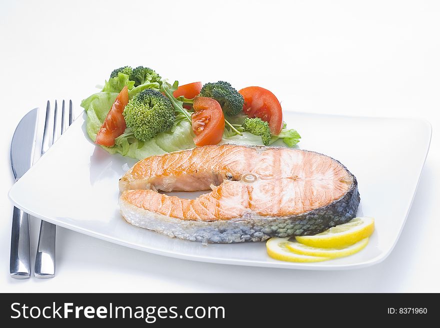 Fresh salmon cooked with tomato salad broccoli salad. Fresh salmon cooked with tomato salad broccoli salad