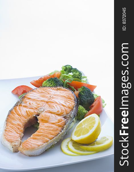 Fresh salmon cooked with tomato salad broccoli salad. Fresh salmon cooked with tomato salad broccoli salad