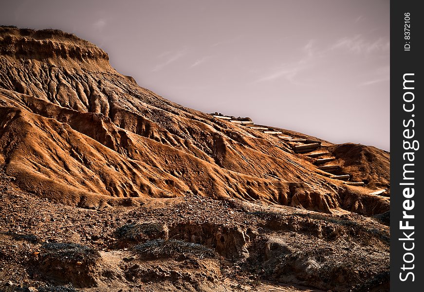 Deceivingly large, this deserted, weathered mountain leads to a brilliant vista of the ocean.