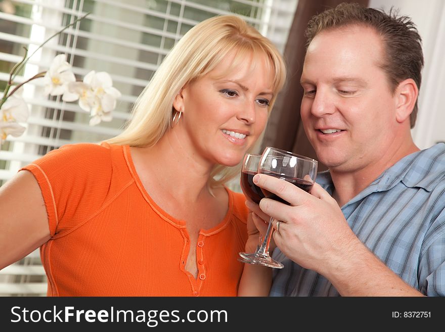 Happy Couple Enjoying a Glass of Wine the Kitchen. Happy Couple Enjoying a Glass of Wine the Kitchen.