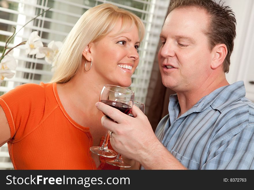 Happy Couple Enjoying a Glass of Wine the Kitchen. Happy Couple Enjoying a Glass of Wine the Kitchen.