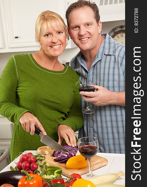 Happy Couple Enjoying An Evening Preparing Food in the Kitchen.