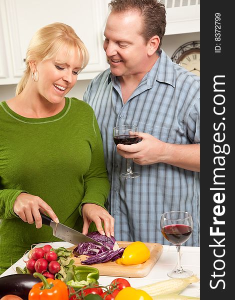 Happy Couple Enjoying An Evening Preparing Food in the Kitchen.