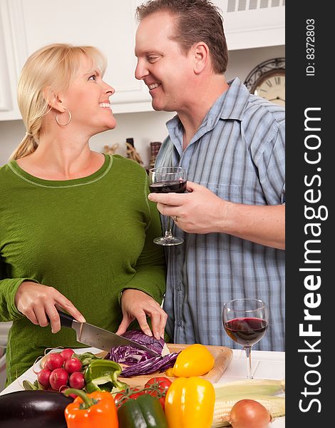 Happy Couple Enjoying An Evening Preparing Food in the Kitchen.