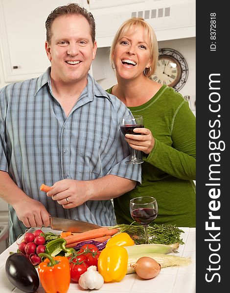 Happy Couple Enjoying An Evening Preparing Food in the Kitchen.