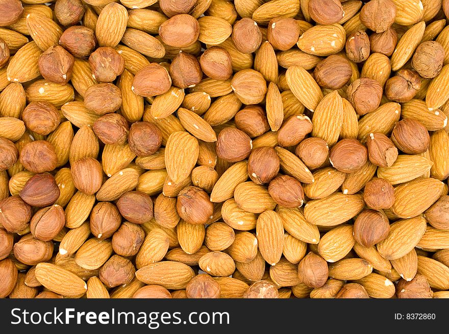 Such nuts as: almonds, a filbert, as a background. Such nuts as: almonds, a filbert, as a background