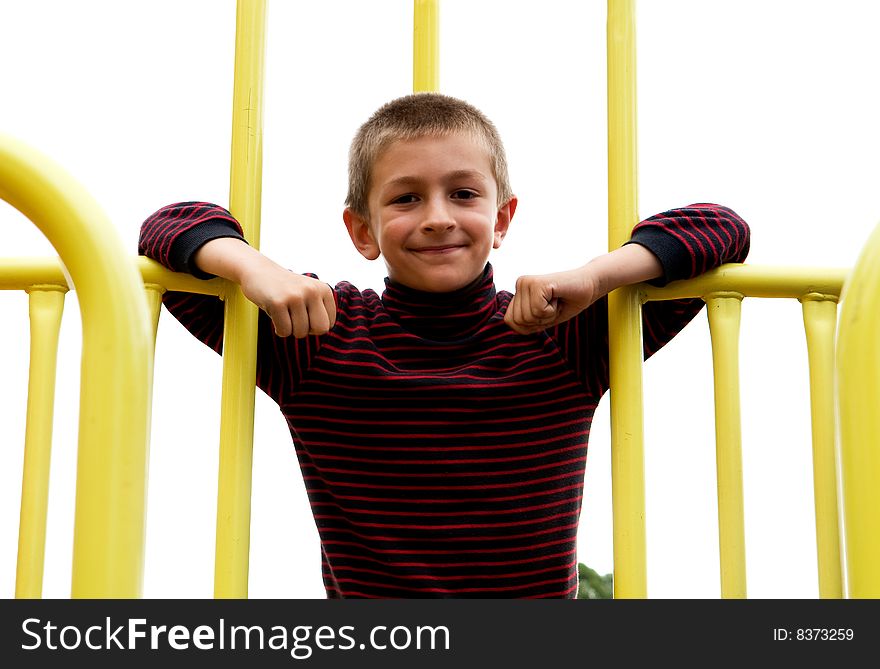 A young boy playing in a public park. A young boy playing in a public park