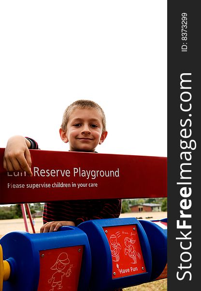 A young boy playing in a public park. A young boy playing in a public park