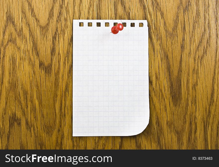 Single blank note paper attached to a wooden wall
