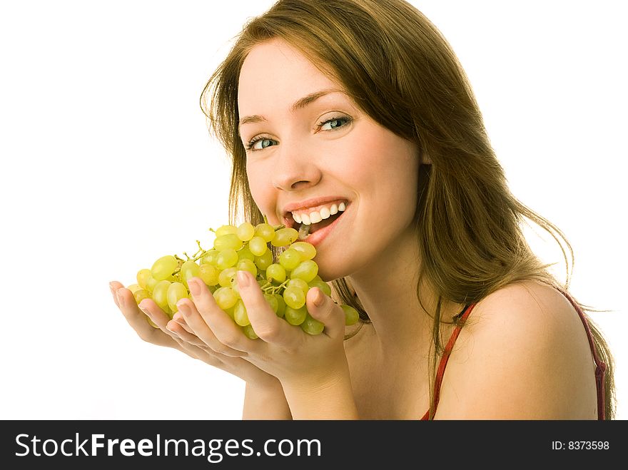 Portrait of a cheerful young beautiful woman eating grapes. Portrait of a cheerful young beautiful woman eating grapes