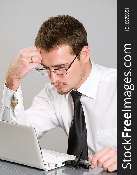 Handsome young businessman working with laptop