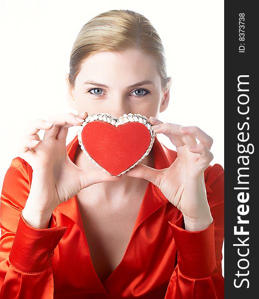 The girl in red holds heart in hands. The girl in red holds heart in hands