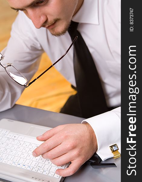 Handsome young businessman working with laptop