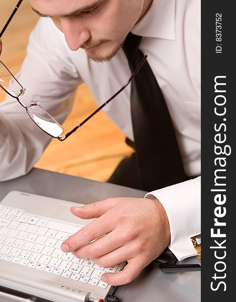 Handsome young businessman working with laptop