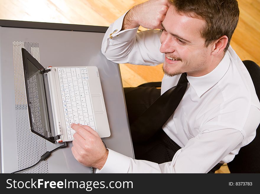 Handsome young businessman working with laptop