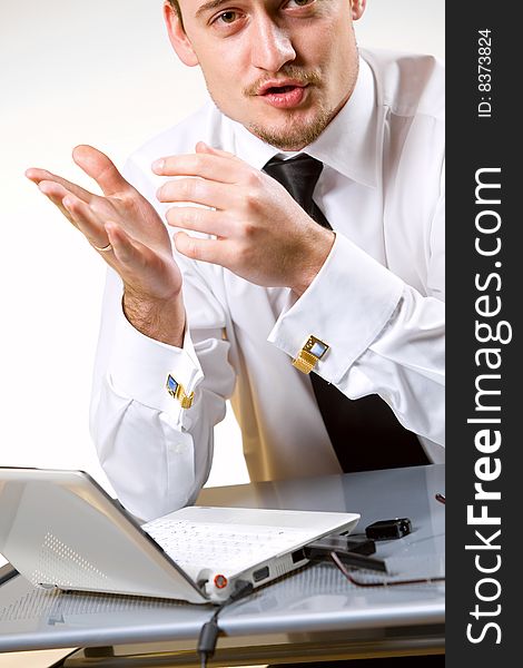 Handsome young businessman working with laptop