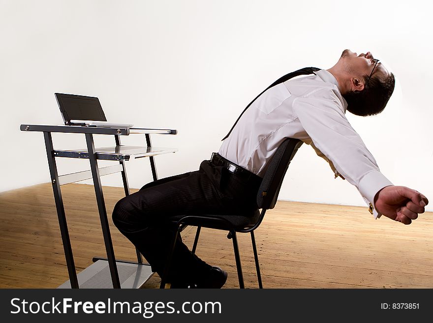 Young hungry businessman eating hamburger